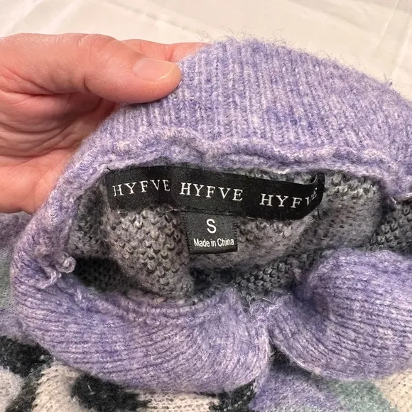 Woman’s purple and black sweater by HyFve